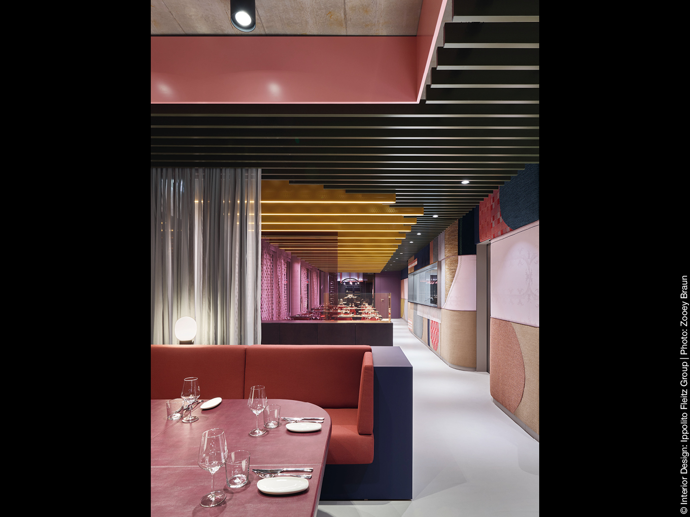 Tisch und Sitzbank in einem Restaurant mit bunter Wandgestaltung