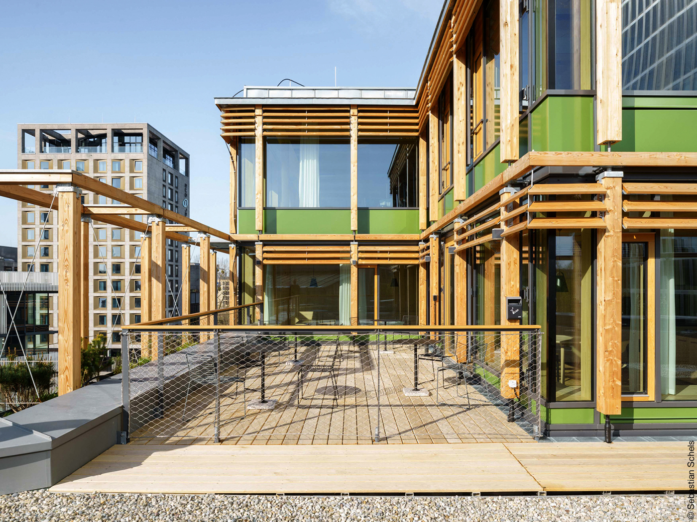 Dachterrasse des Alpenvereins mit Holzdielen, Holzpfeilern und Drahtzaun.