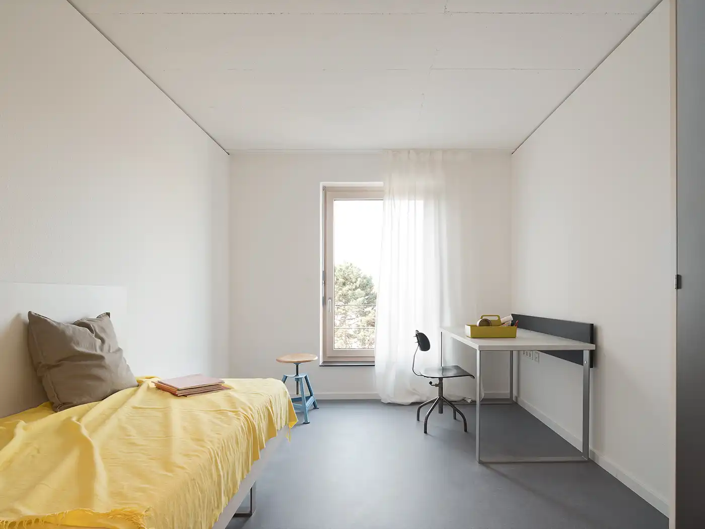 Zimmer im Studierendenwohnheim in Ludwigsburg mit gelber Bettwäsche